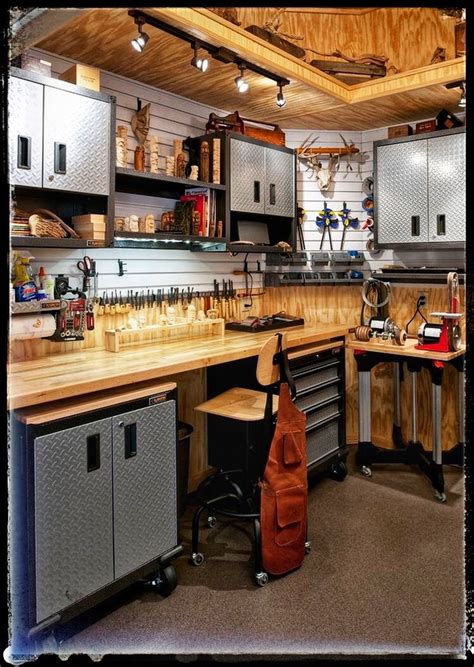 A Workbench With Lots Of Tools On The Counter And Cabinets Above It In