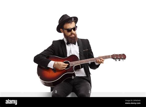 Bearded Man Playing An Acoustic Guitar And Sitting On A White Banner