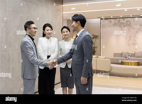 Successful Chinese Business People Shaking Hands Stock Photo Alamy