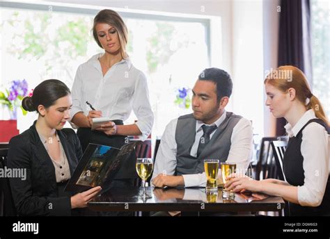 Three Business People Ordering Dinner From Waitress Stock Photo Alamy