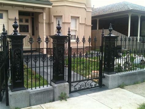 Black Wrought Iron Front Yard Fence With Decorative Artworks And Swing Gate Between Black