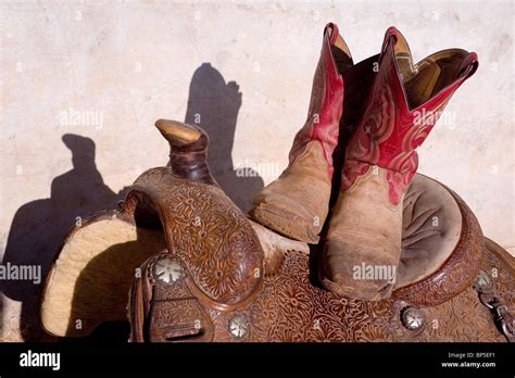 Cowboy Boots On Western Saddle Stock Photo Alamy