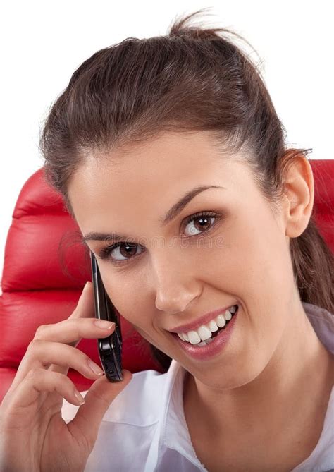 Beautiful Business Woman Talking On Mobile Phone Sitting On A Red Chair