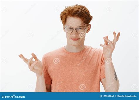 Smart Ginger Man With Freckles In Round Glasses And Orange T Shirt