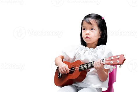 Asian Girl Practicing Playing Ukulele With Intent Expression Learning