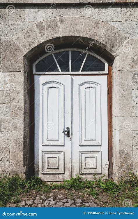 Old Abandoned White Wooden Door In House At Town Street Stock Photo