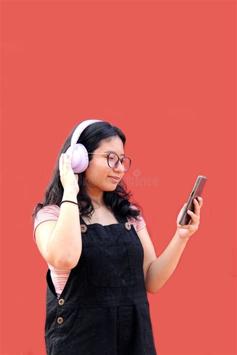 Female Latina Teenager Of Years Old Uses Her Cell Phone And Audio To Connect To Music