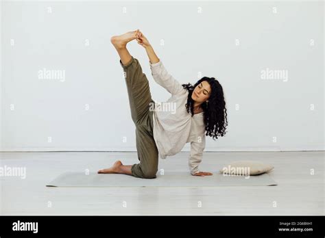 Beautiful Woman Brunette Engaged In Yoga Asana Gymnastics Flexibility