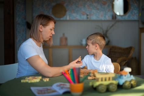 Mãe brincando seu filho autista usando brinquedos Foto Grátis