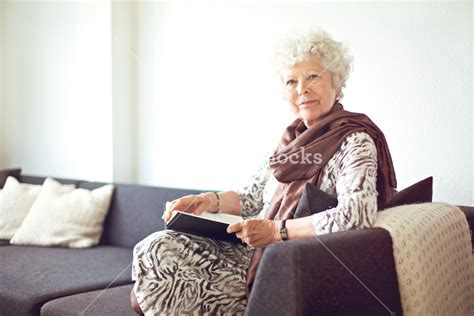 Relaxed Grandmother Sitting On The Couch At Home Royalty Free Stock