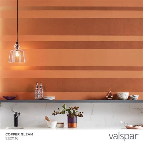 An Orange Wall In A Kitchen Next To A Counter With Plates And Cups On It