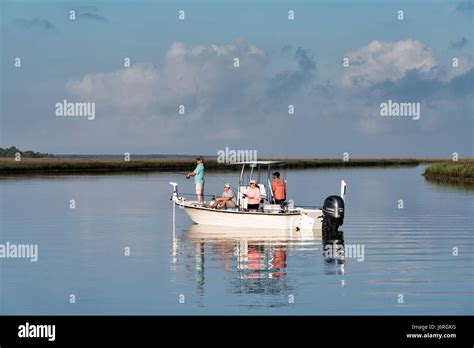 People Fish From A Small Boat In The Salt Marshes Of The Cape Romain