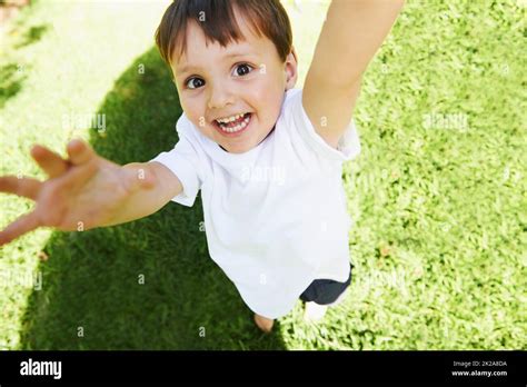 Yay Its time to play. High angle view of a little boy reaching up into ... 