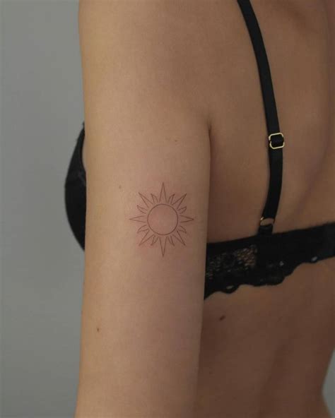 Fine Line Sun Tattoo Located On The Tricep