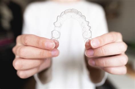 Premium Photo Close Up Of A Womans Hand Holding Invisible Aligners