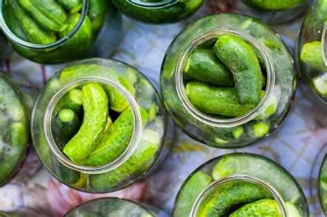 Premium Photo Pickling Cucumber Processgherkins In Jars Top View