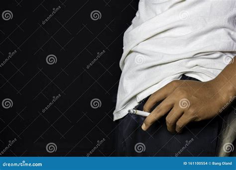 Hand Of Asian Man Holding Cigarettes With Black Background Smoking