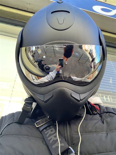 A Person Wearing A Helmet And Holding A Camera