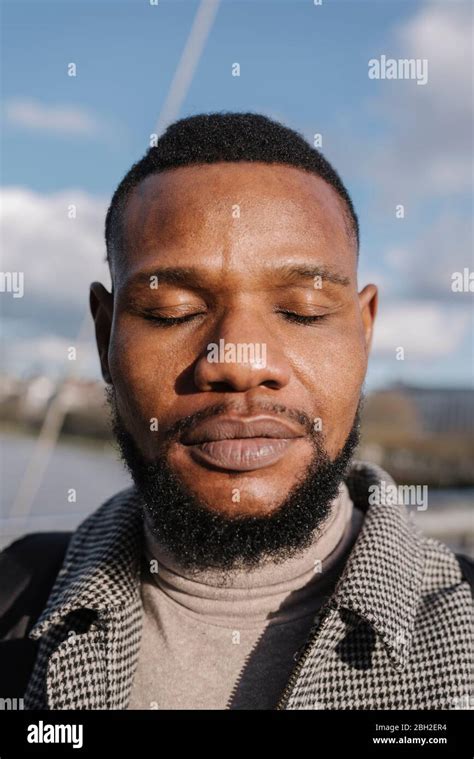 Portrait Of Man With Closed Eyes Outdoors Stock Photo Alamy