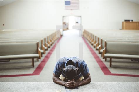 A man kneeling in prayer at an altar — Photo — Lightstock