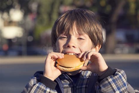 Boy Eating A Hamburger Stock Image Image Of Lifestyle 46879529