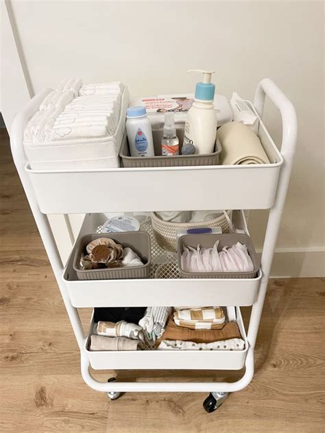 A White Cart Filled With Lots Of Bathroom Items