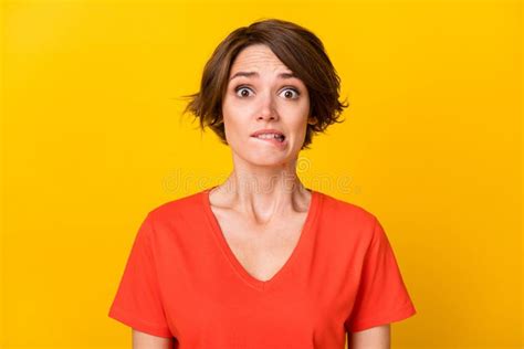 Photo Of Sad Nice Brunette Lady Bite Lip Wear Orange T Shirt Isolated