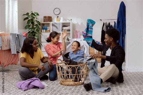 Daughter And Son Help Mother And Father With Household Chores The