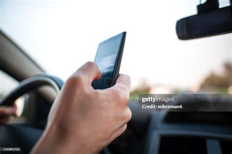 Man Using Smartphone Whilst Driving Internet Addicted High Res Stock