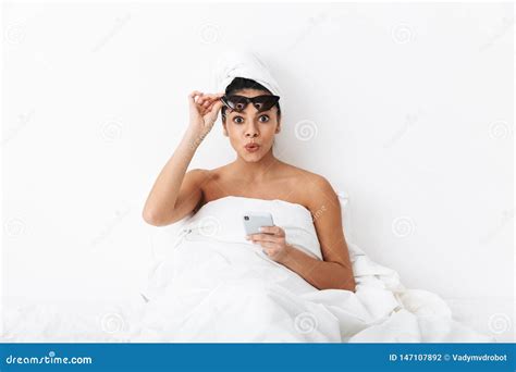 Beautiful Surprised Emotional Woman With Towel On Head Lies In Bed