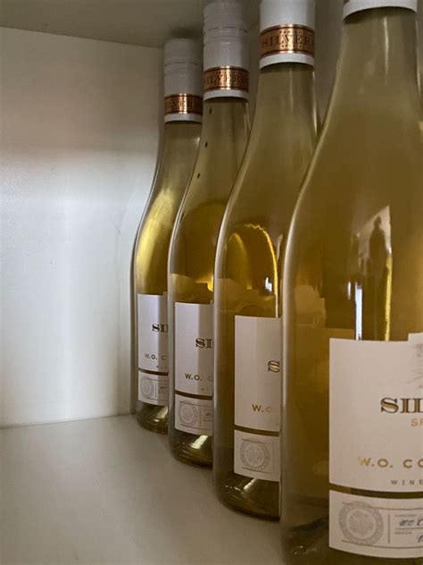 Several Bottles Of Wine Are Lined Up On A Shelf