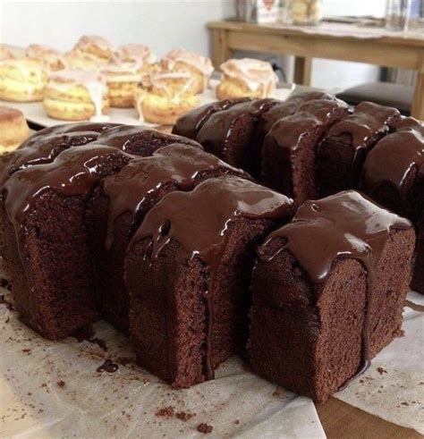 Chocolate Bundt Cake Sitting On Top Of A Table Next To Other Pastries