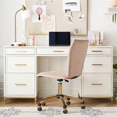 A Desk With A Chair Laptop And Pictures On The Wall Above It In A Room