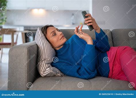 Attractive Woman Lay Down On Sofa Pillow Using Smartphone Web Surfing