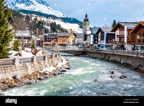 The Village Of Lech In The Snow With The River Lech In The Foreground