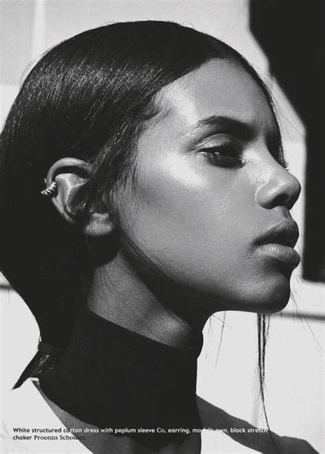 A Black And White Photo Of A Woman With Ear Piercings