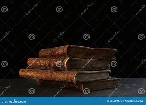 Old Books Four Volumes Of Old Books On A Black Background The Concept