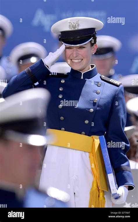 A Female Us Air Force Academy Cadet Salutes During Graduation Ceremony