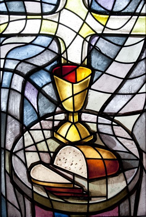 A Stained Glass Window With A Candle And Bread