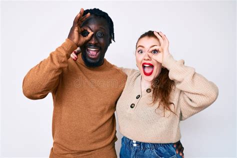 Interracial Couple Wearing Casual Clothes Doing Ok Gesture With Hand