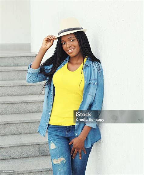 Beautiful Smiling African Woman Wearing Straw Hat And Jeans Clothes