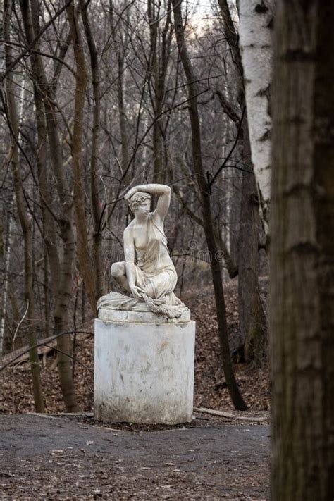 Statue Of A Seated Half Naked Woman In A Park Stock Photo Image Of