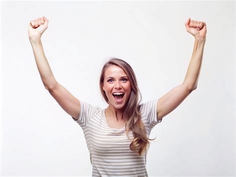 Premium Photo A Young Women Raising Both Arms In Triumph