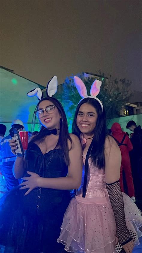 Girls Friends Dressed In Pink And Black Bunny Costumes For Halloween