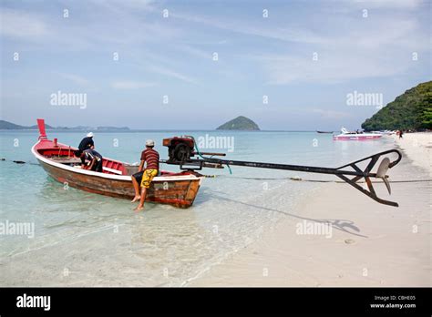 Traditional Thai Long Tailed Boat And Crew And Tropical Seascape On