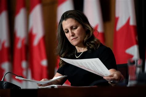 Behind the photo of Chrystia Freeland holding a black-and-red scarf at ...