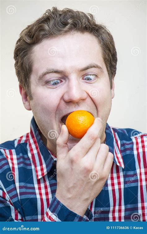 Man Trying To Swallow Whole Tangerine Stock Photo Image Of Facial