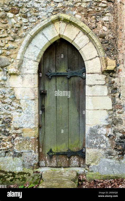 Small Narrow Arched Timber Doorway With Ornate Cast Metal Hinges With