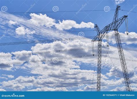 Pylons Of High Voltage Power Lines And A Blue Sky With Clouds Royalty