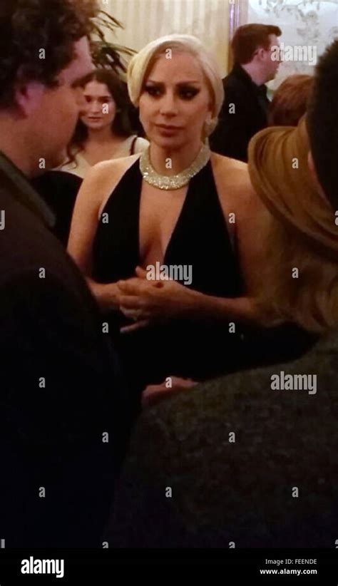 Lady Gaga Showing Her Cleavage Wearing An Ultra Low Cut Black Dress